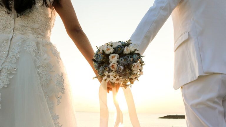 A married couple holding hands after reading marriage Bible verses.