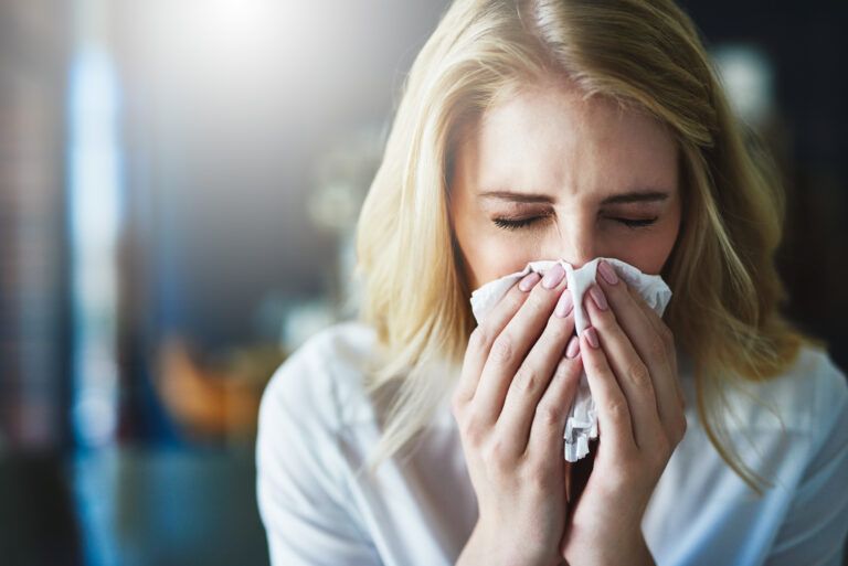 Woman sneezing