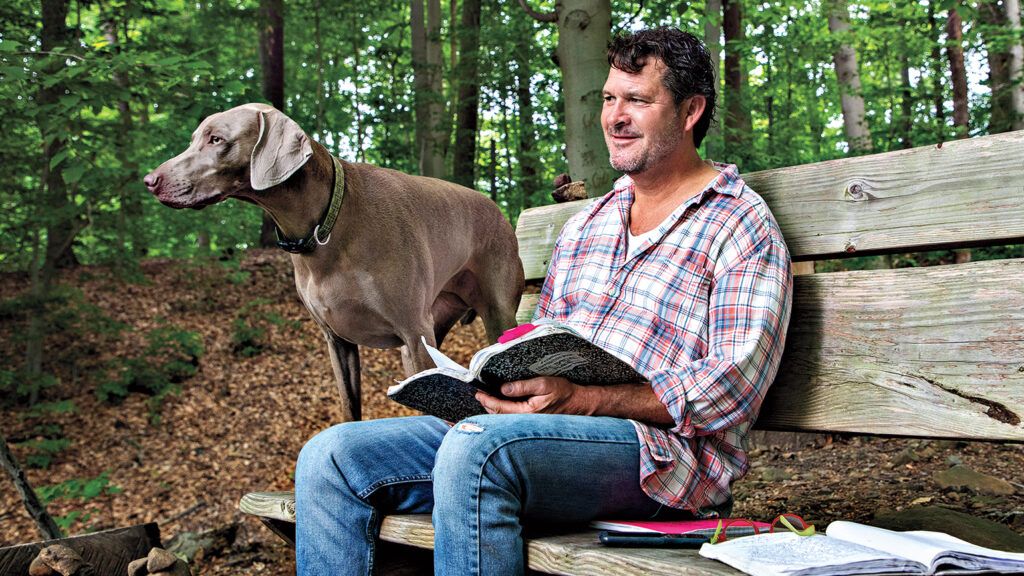 Mark and new Weimaraner Hazel on the bench he made