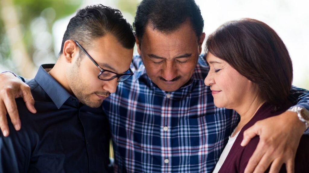 A family in prayer.