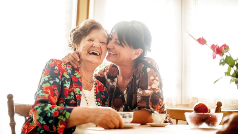 A daughter taking care of her mother while having a laugh.