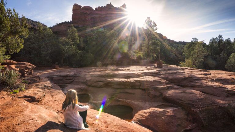 A girl sitting on the rocks of Sedona, Arizona.