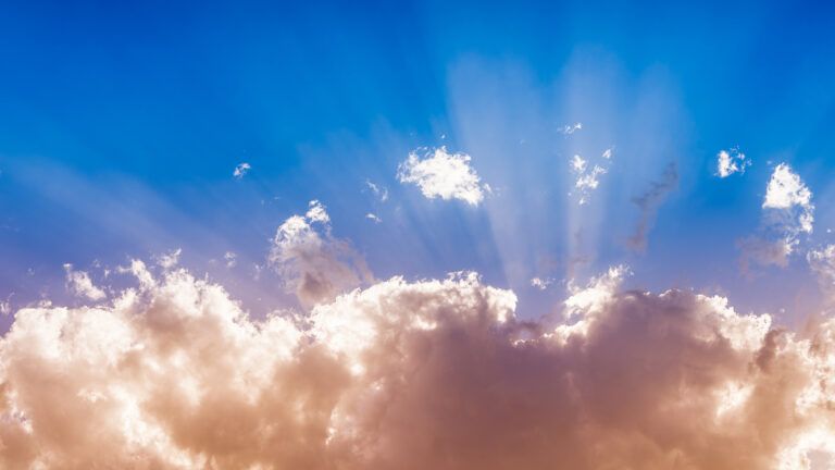 Sunbeams stream through clouds