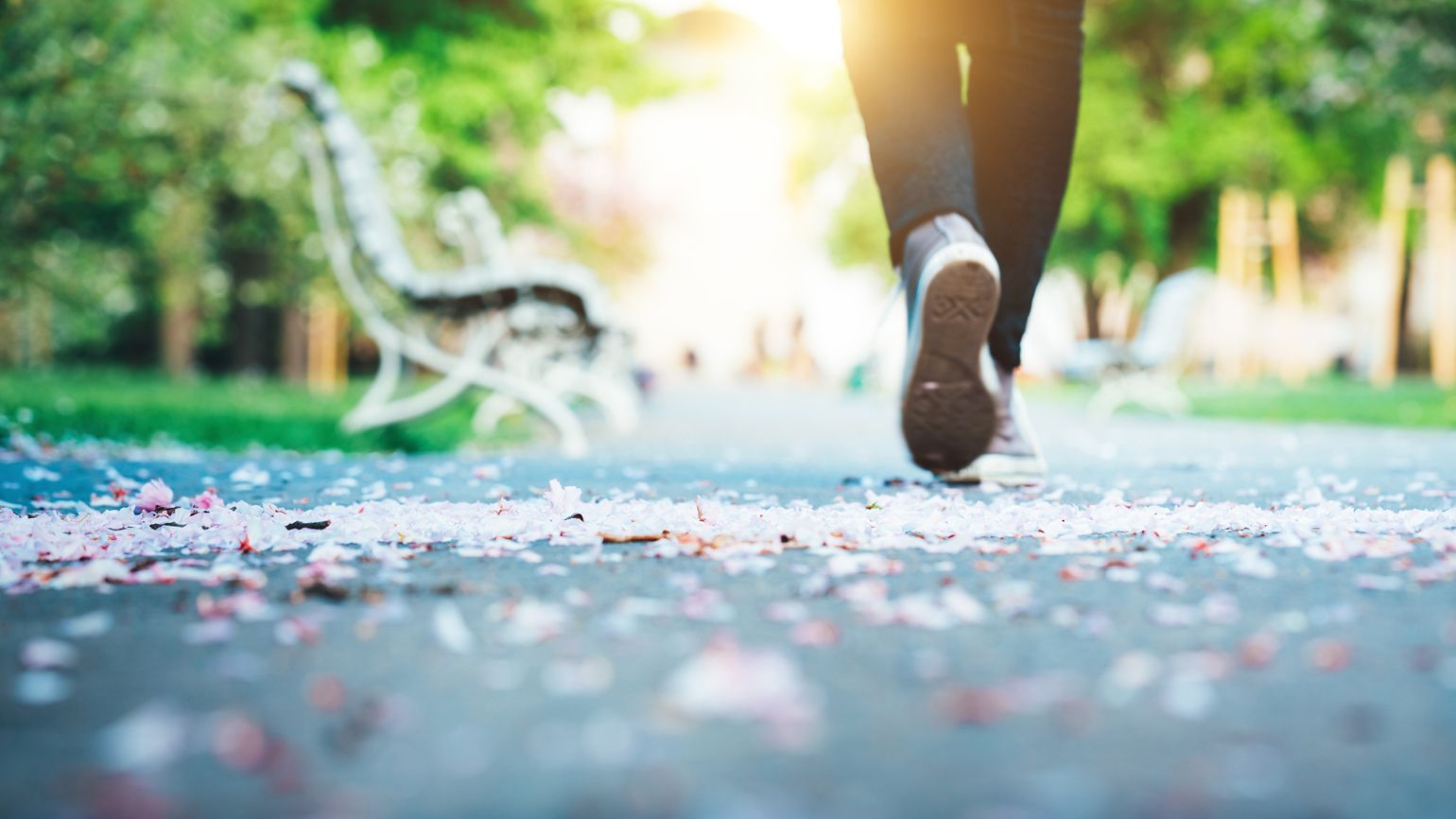 A close up of a person walking down a path.