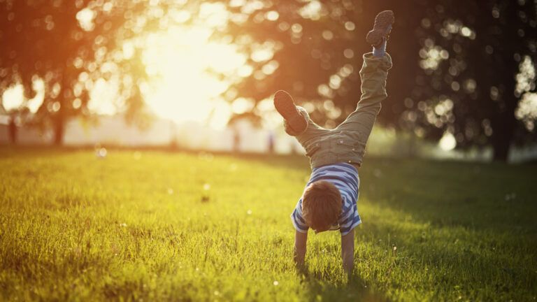 A child plays on the grass.