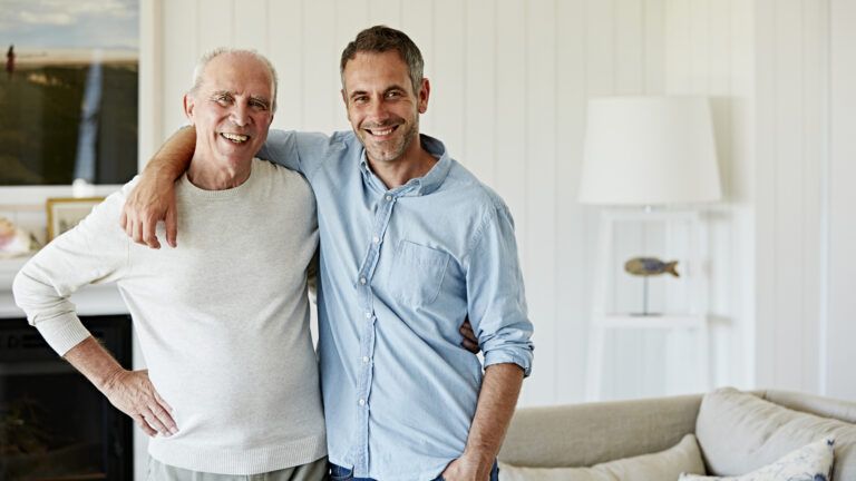 Portrait of a smiling father and son at home.