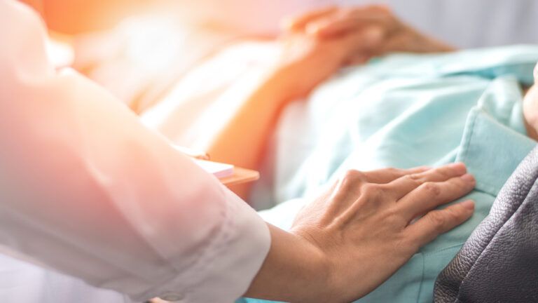 A caregiver comforts an Alzheimer's patient