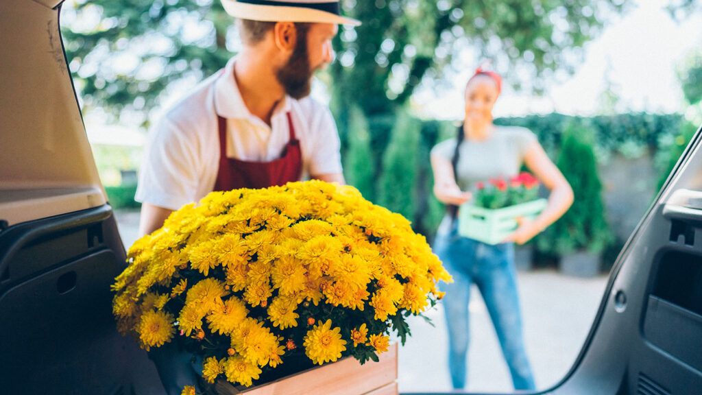 Man delivering flowers to a young woman