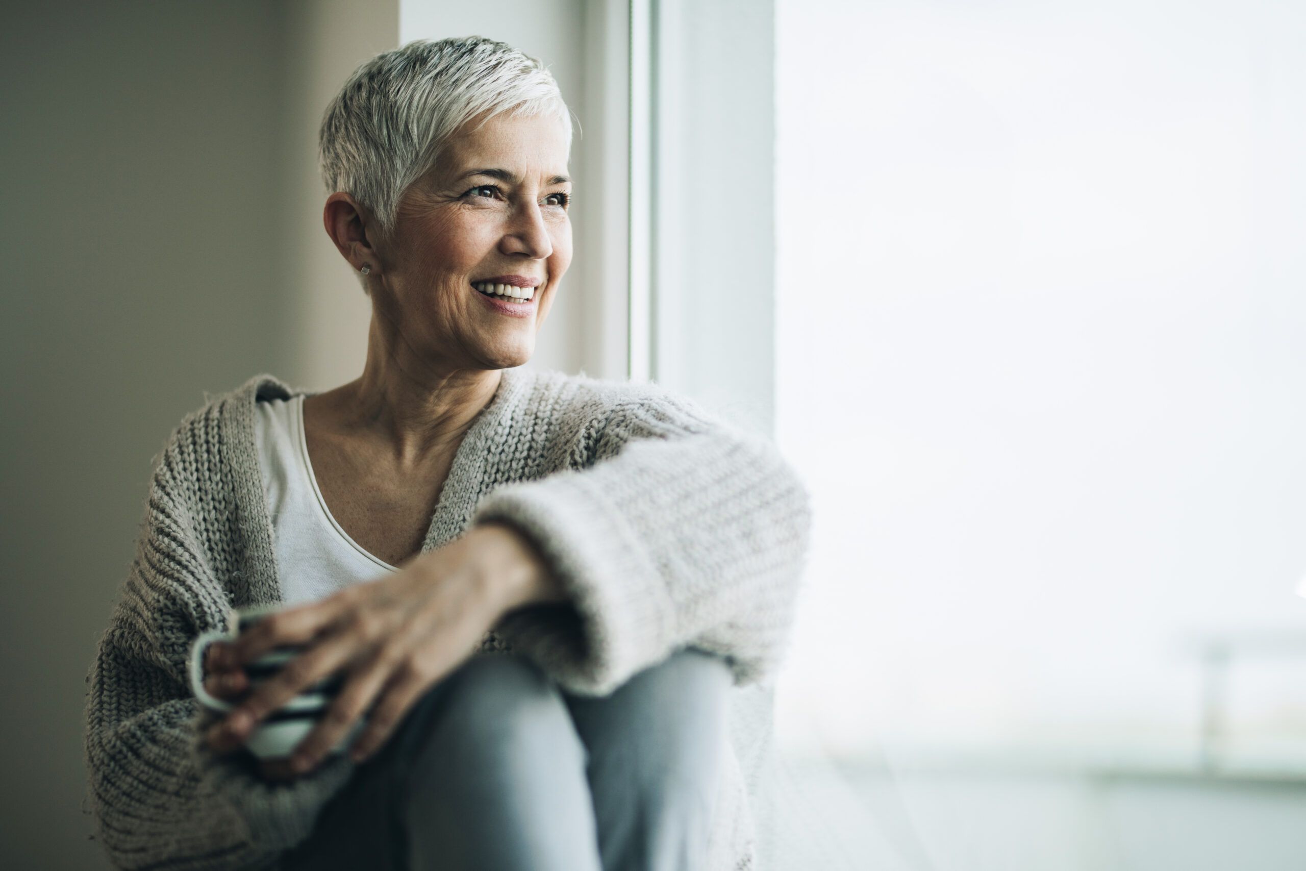 Happy woman looking out the window