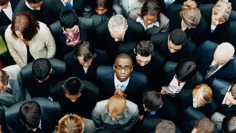 A man stands alone in a crowd