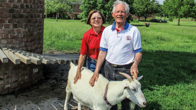 The Johnsons posing with their goat