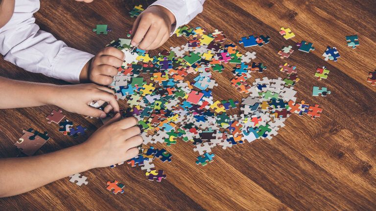 A family works together on a jigsaw puzzle