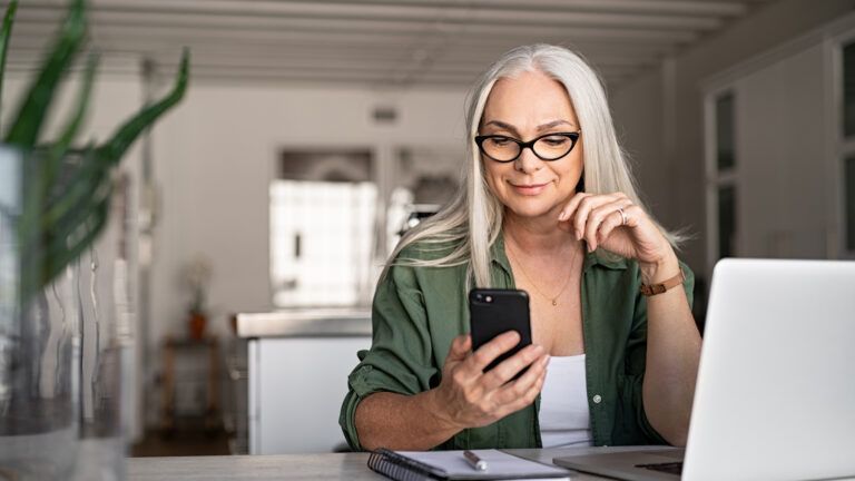 A woman calling someone on her mobile phone.