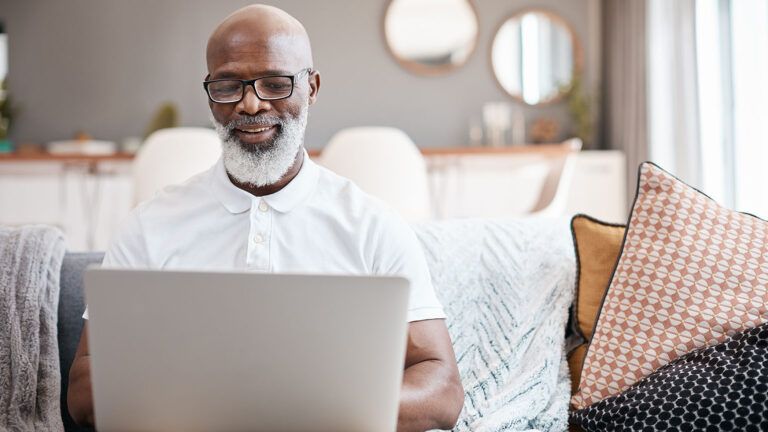 Man smiling at laptop