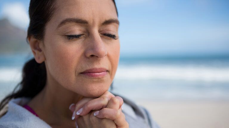 A woman listens prayerfully