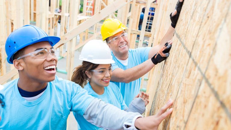 Volunteers helping to build a house