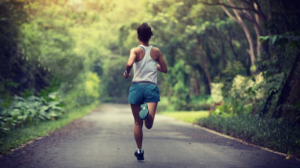 A woman running in the woods.