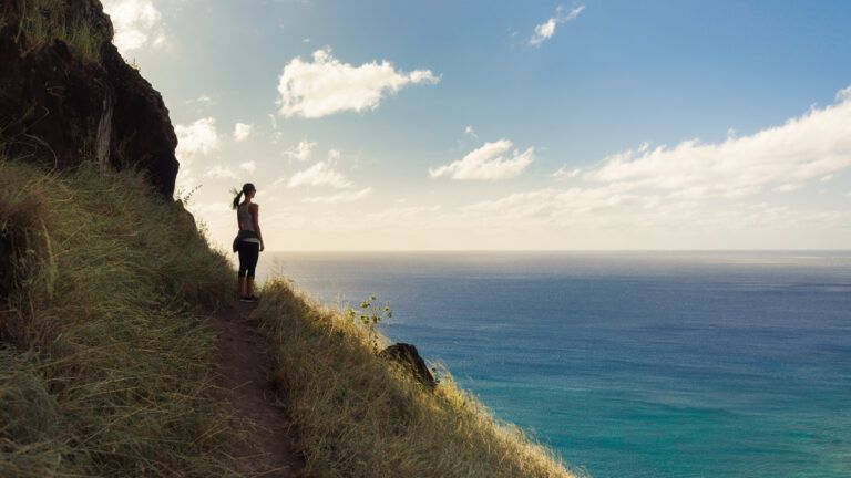 Woman hiking by the water