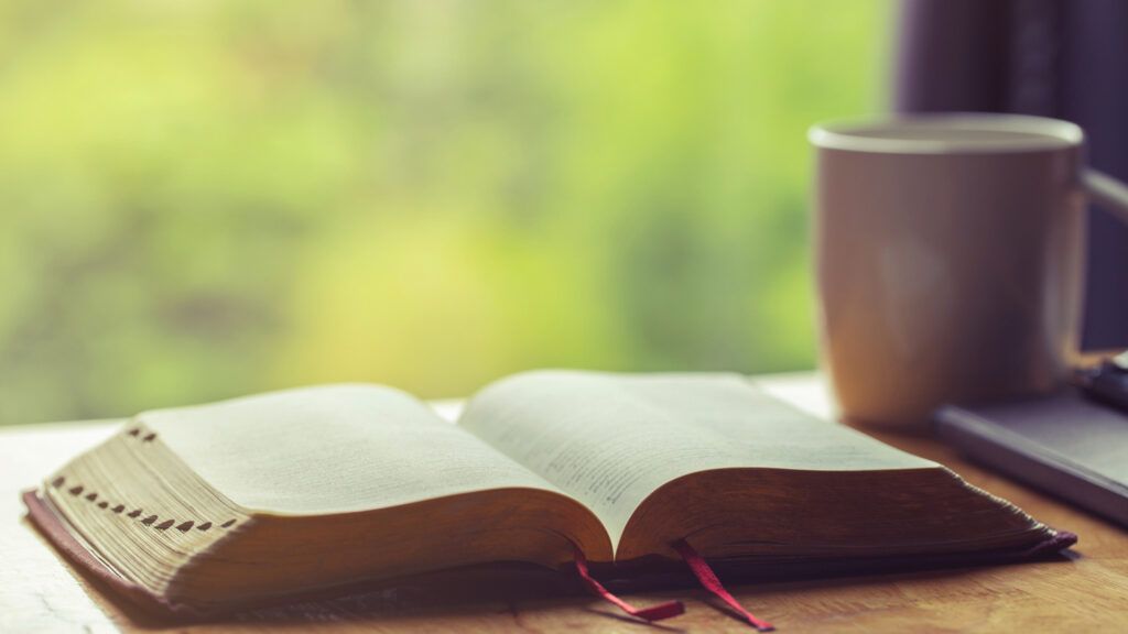 A Bible and a cup.