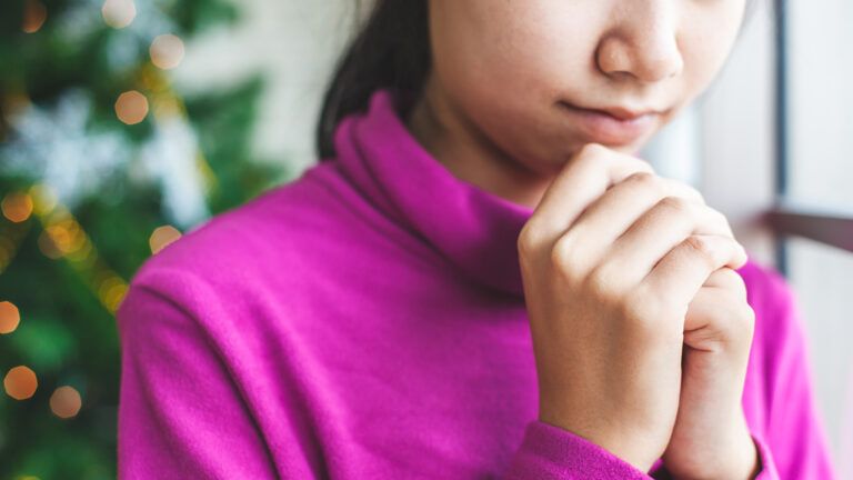 A woman prays on Christmas