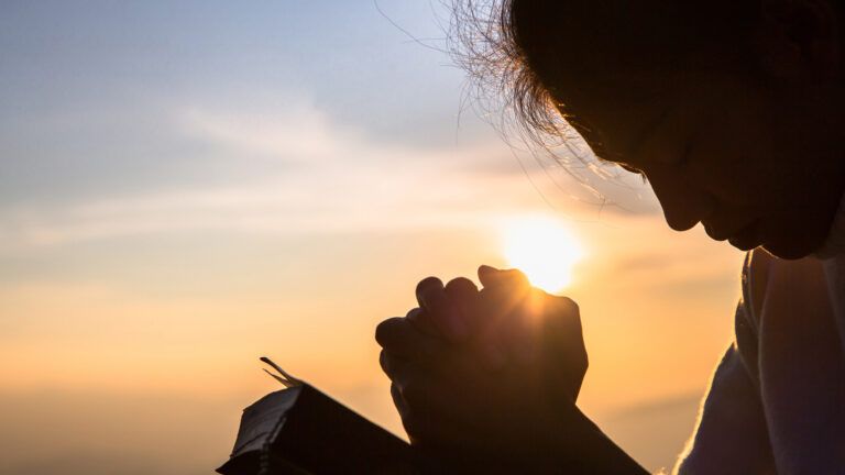 A young girl in prayer; Getty Images