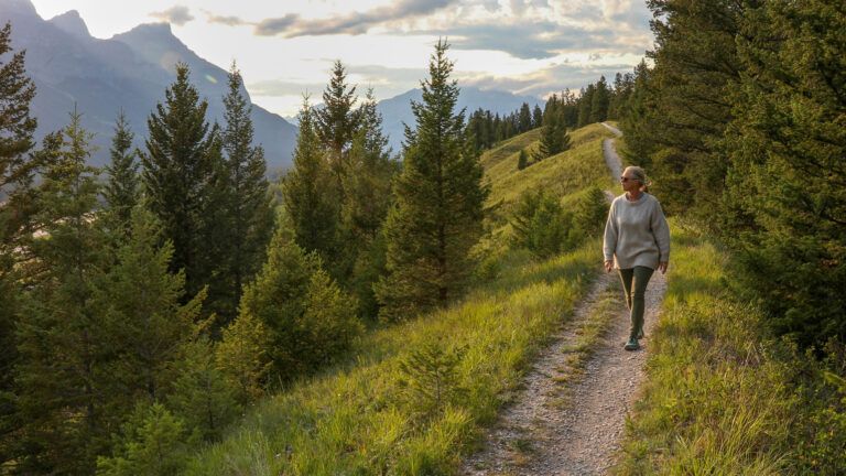 A woman taking a scenic stroll outdoors; Getty Images