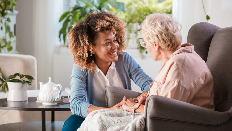 Senior woman and her caregiving nurse