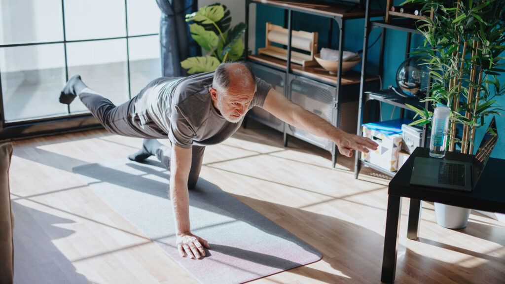 A man doing an indoor yoga class; Getty Images