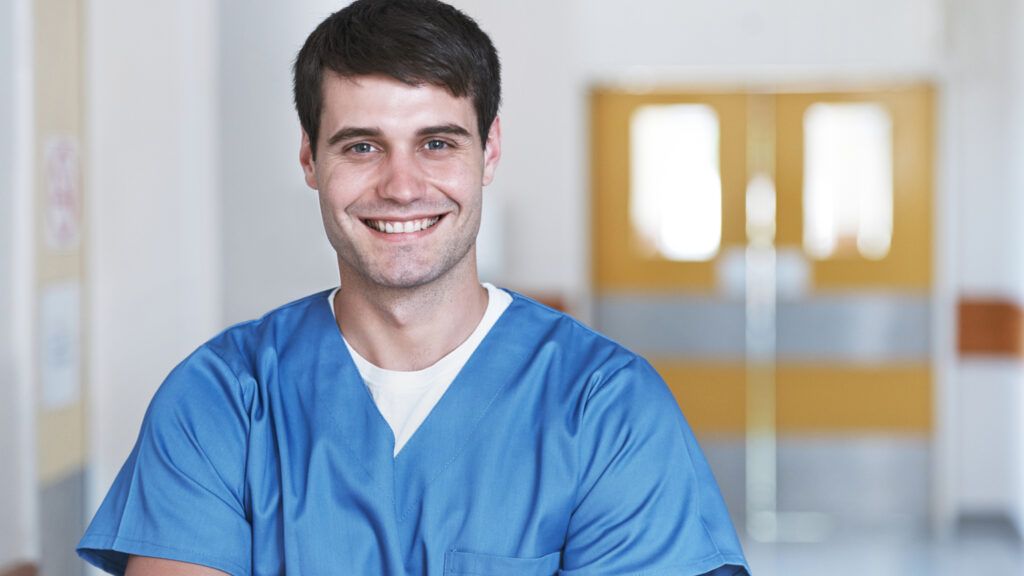 A smiling male aide; Getty Images