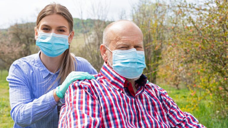 A female caregiver taking care of a patient; Getty Images