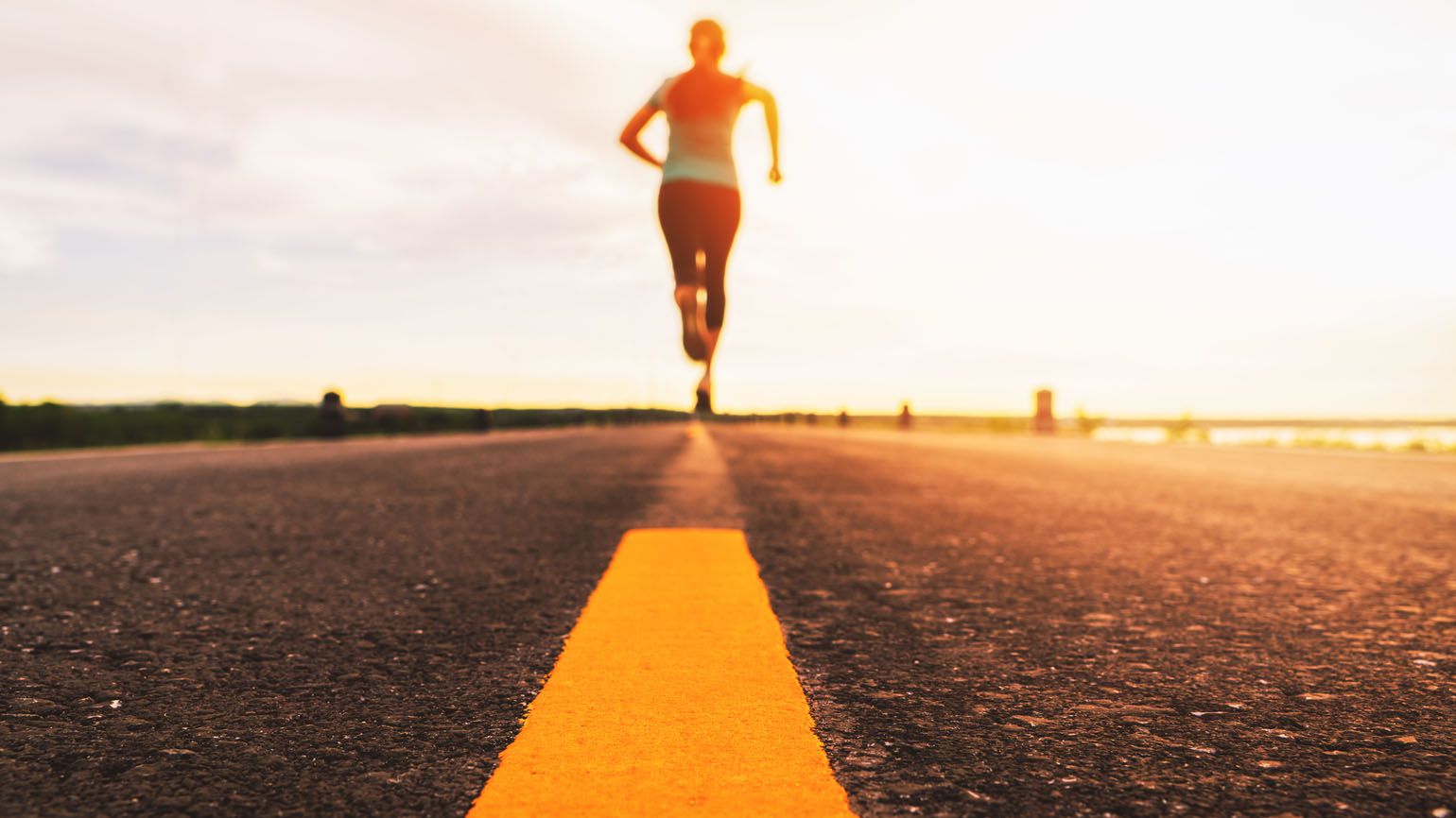 Woman running on the road; Getty Images