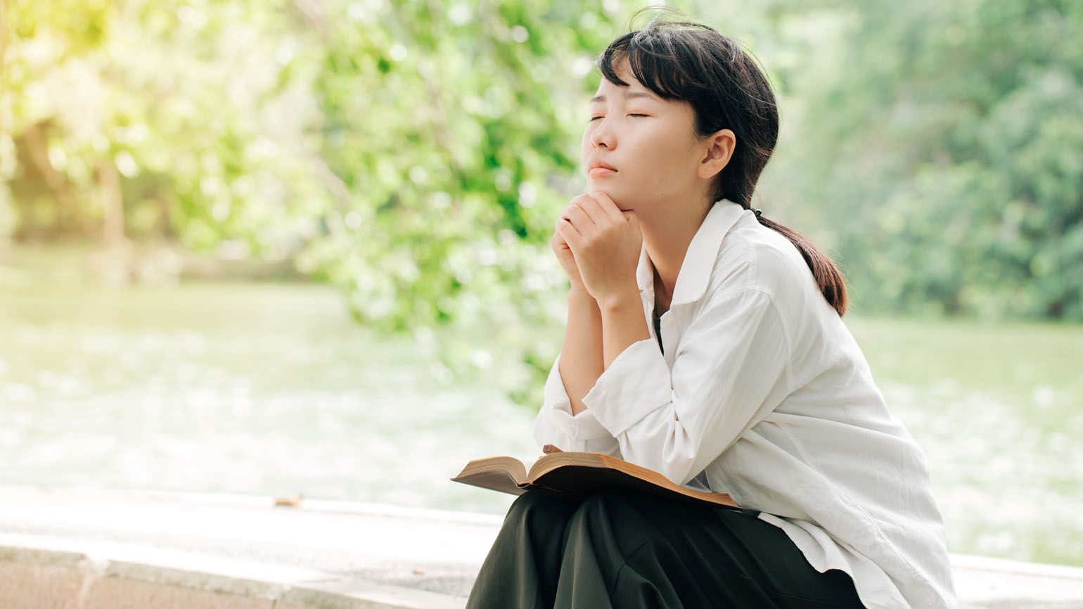 A woman praying; Getty Images