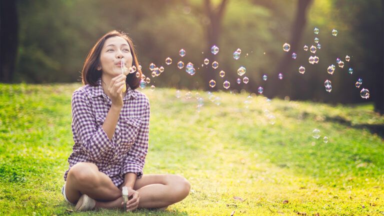 A woman blowing bubbles