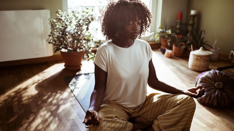 Young man meditating in the morning; Getty Images