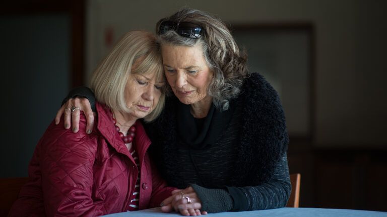 Senior women hugging