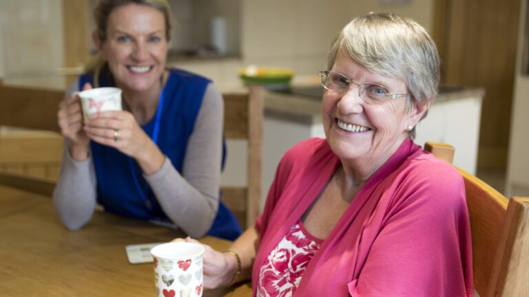 A caregiver with her senior mother having quality time; Getty Images