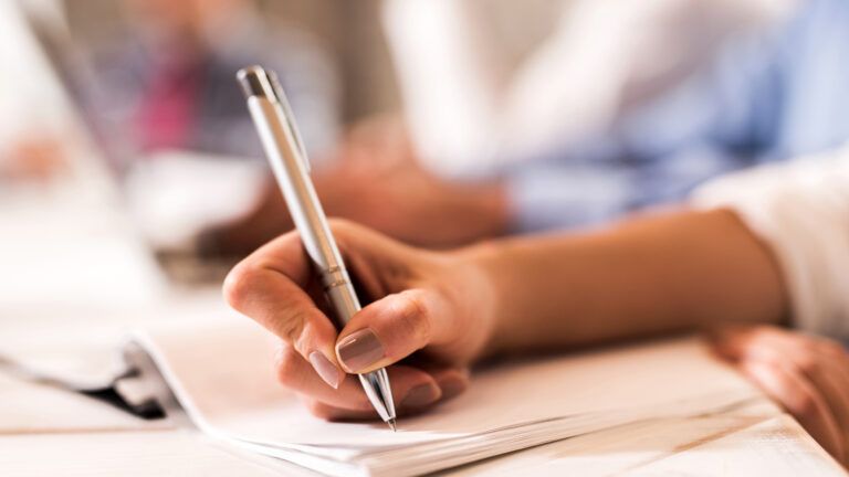 Woman writing in notebook