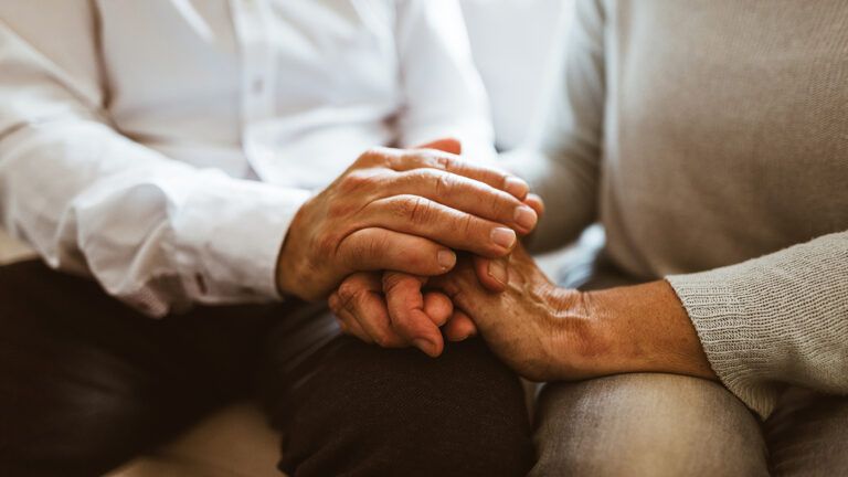 Senior couple holding hands