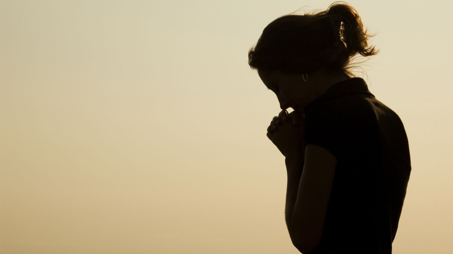 Silouette of a woman praying; Getty Images