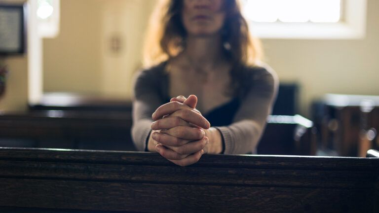 Woman praying in church