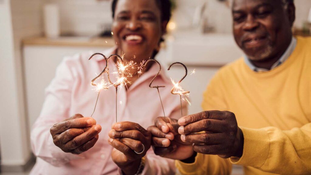 Couple lighting sprinklers for 2022 New Year's Eve; Getty Images