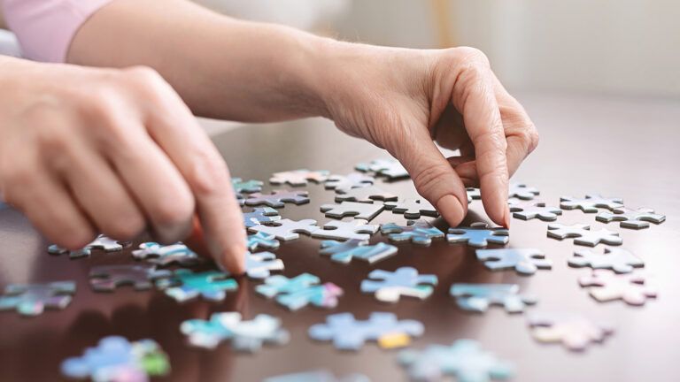 A pair of hands doing a puzzle