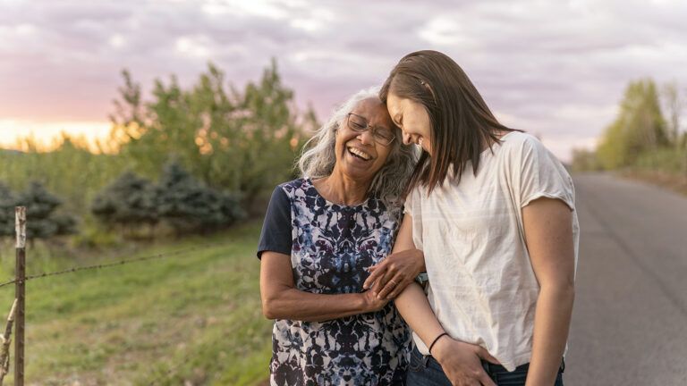 Adult woman and senior mother on an outdoor walk