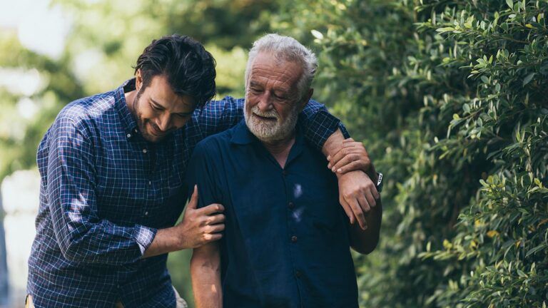 Adult man and senior man spending time together outdoors