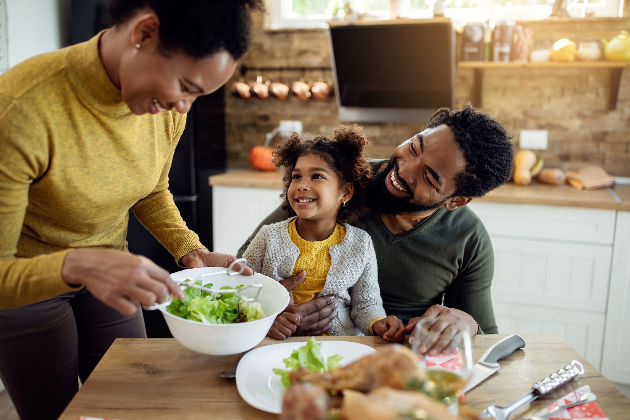 A family cooking together and talking about God's hands