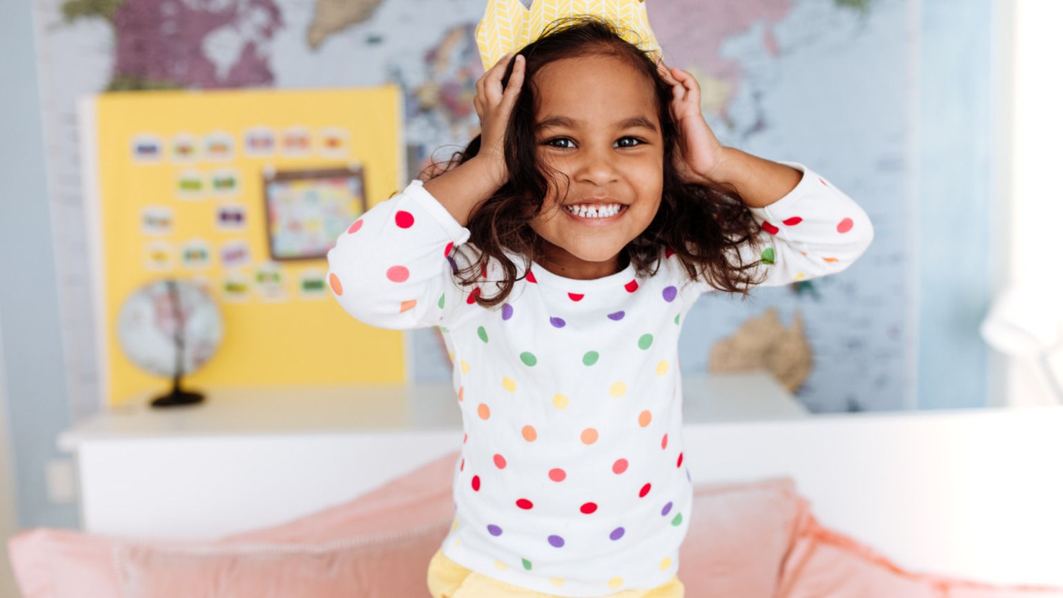 A little girl in a crown learning about God's hands