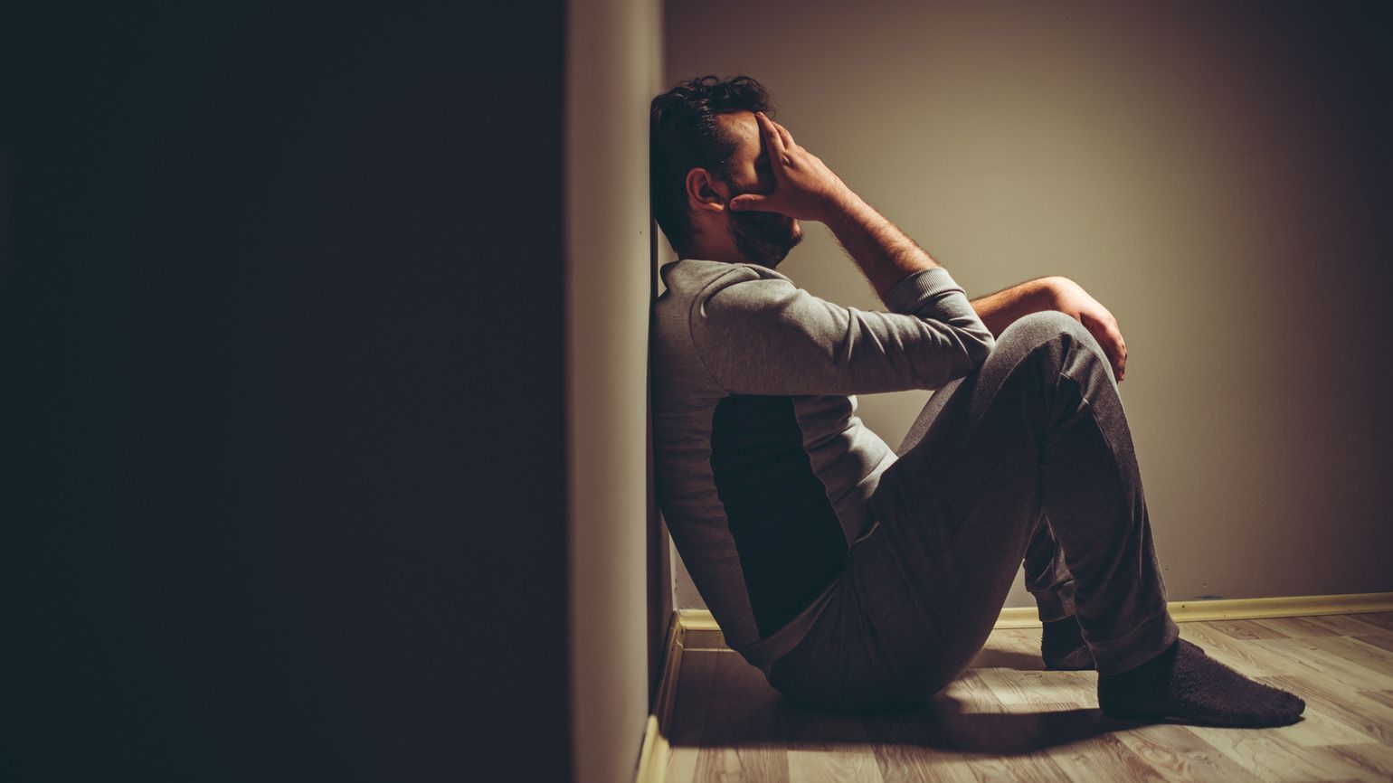 A depressed man praying for the help of God's hands