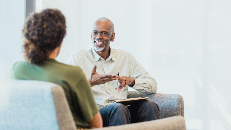 Man cheerfully talking to woman