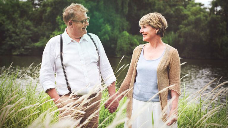 Senior couple holding hands