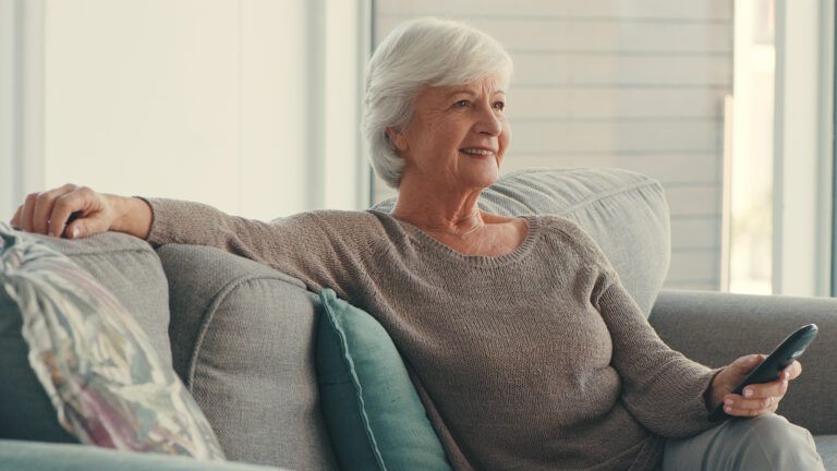 Senior woman watching TV